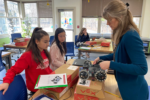 Middle school kids learning about robotics