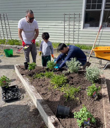 Parents planting in a garden