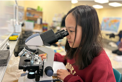 Student using microscope